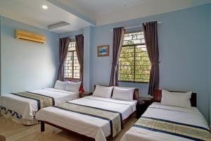 Giường trong phòng chung tại NGOC LINH MOTEL