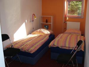 a bedroom with two beds and two chairs at Ferienwohnung Welle in Freest