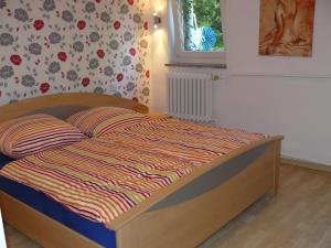 a bedroom with a bed with a colorful comforter at Ferienwohnung Welle in Freest