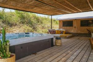 a hot tub on a deck with a tent at Cabane Ayana in Saint-Maximin-la-Sainte-Baume