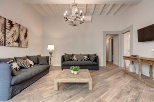 a living room with a couch and a table at Lambert Apartment in Florence