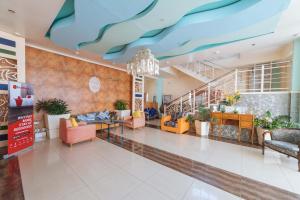 a lobby with couches and a blue ceiling at RedDoorz Plus @ San Roque Roxas City in Roxas City