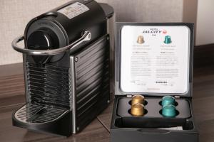 a small black refrigerator with three balls in it at Hotel JAL City Nagasaki in Nagasaki