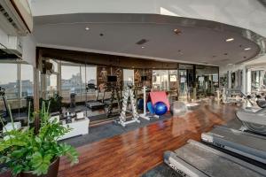 a gym with treadmills and exercise equipment in a building at Donatello Hotel in Dubai