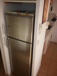 a stainless steel refrigerator in a kitchen at Les Andalouses in Cap d'Agde