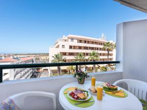 a table with two plates of food on a balcony at 427 BEAUTIFUL SUMMERLAND STUDIO Wi-Fi Sat-Tv in El Guincho