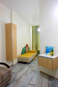 a room with two beds and a table in it at Золотой Бугаз in Gribovka