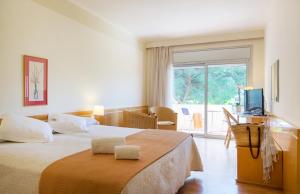 En eller flere senger på et rom på Hotel Ancora