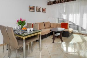 a living room with a couch and a table at Family Homes - Apartamenty Sonoma in Władysławowo