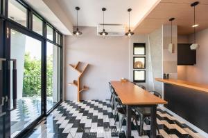 a kitchen with a checkered floor and a wooden table at 懶人旅宿 in Xiaoliuqiu