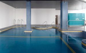 a swimming pool with a blue floor and blue walls at Radisson Blu Hotel, Liverpool in Liverpool