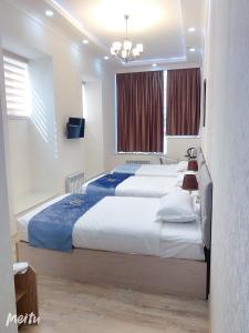 Ένα ή περισσότερα κρεβάτια σε δωμάτιο στο WANTONG HOTEL