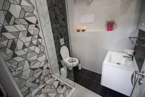 a bathroom with a toilet and a sink and a shower at Huge Stylish Apartment Monroe 1 / City Centre in Plovdiv +53 photos