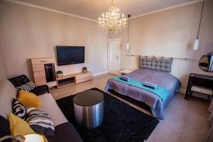 a living room with a bed and a couch at Huge Stylish Apartment Monroe 1 / City Centre in Plovdiv