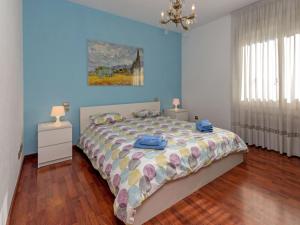 a bedroom with a bed and a blue wall at Apartment Sants-Les Corts Galileu by Interhome in Barcelona