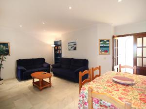a living room with a couch and a table at Holiday Home Brisamar - Novo Sancti Petri by Interhome in Chiclana de la Frontera