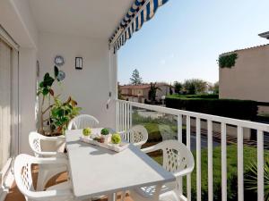 - Balcón con mesa blanca y sillas en Apartment Edificio Blanqueries-2 by Interhome, en Calella