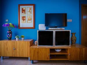 A television and/or entertainment centre at Apartment Segrelles by Interhome