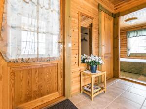 a room with a door and a table with flowers at Holiday Home Kallionnenä by Interhome in Mäkikylä