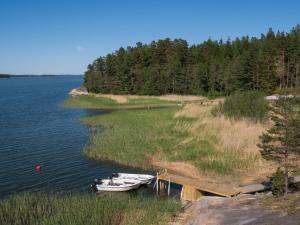 two boats are docked at a dock on a lake at Holiday Home Merimetso by Interhome in Karuna