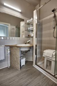 a bathroom with a sink and a shower at Rouge Hotel International in Milano Marittima