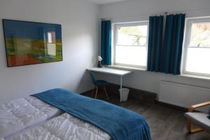 מיטה או מיטות בחדר ב-Ferienwohnung Nunatak am Plöner See