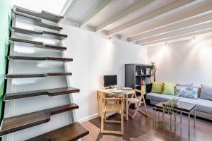 a living room with a spiral staircase and a couch at Fabuloso estudio en pleno centro de Madrid. in Madrid