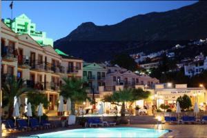 a hotel with a swimming pool in front of a building at Hotel Pirat in Kalkan