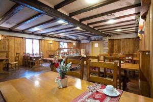 a dining room with wooden tables and chairs at Brit Hotel Le Relais d'Issenheim in Issenheim