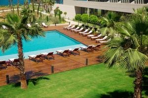 an overhead view of a pool with chaise lounge chairs and a resort at ON'LIVE HOTEL in Çeşme