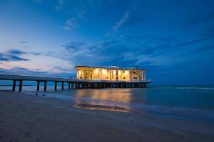 a building on a pier on the beach at Hotel Miramare in Marotta