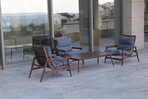 two chairs and a table in a room with windows at ON'LIVE HOTEL in Çeşme