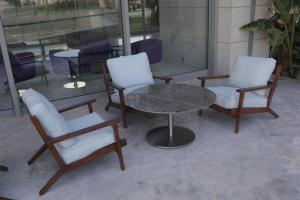 two chairs and a table and a table and chairs at ON'LIVE HOTEL in Çeşme