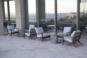a group of chairs and tables in a building at ON'LIVE HOTEL in Çeşme