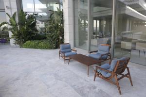 two chairs and a bench in a building at ON'LIVE HOTEL in Çeşme