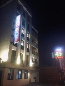 a building with a sign on the side of it at night at Fairy Tale City Motel in Hualien City