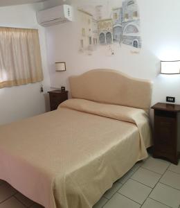 En eller flere senge i et værelse på Hotel Ristorante Bagnaia