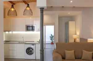 una cucina e un soggiorno con lavatrice e asciugatrice di Balaustrada Apartments a Burjassot