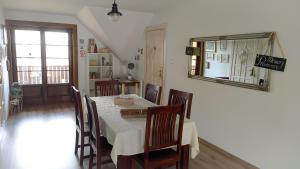 a dining room with a table with chairs and a mirror at Roztoczański Dworek in Zamość