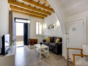 a living room with a couch and a table at Holiday Home Casa Sant Pere by Mauter Villas in Ciutadella