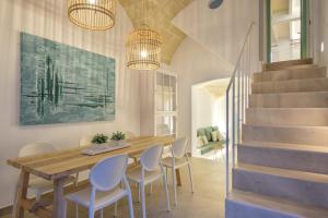 a dining room with a wooden table and chairs at Holiday Home Casa Sa Font by Mauter Villas in Ciutadella