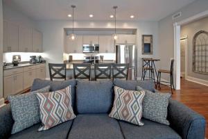 a living room with a blue couch and a kitchen at Newly Renovated 4 bed 3 bath and 2 Parking Spots in Savannah
