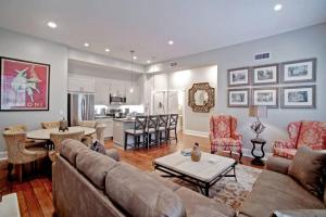 a living room with a couch and a table and a kitchen at Restored Historic Home 5 bedroom 4 and a Half Bath in Savannah