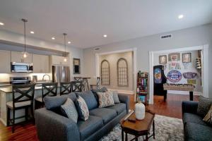 a living room with a couch and a kitchen at Sophisticated Historic Remodeled 9 bedroom Home in Savannah