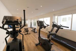 a gym with two treadmills and two exercise bikes at HSM Solivera in Paguera