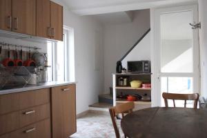 a kitchen with a table and a dining room at Appartement de Charme - Parc du Luberon in Cadenet