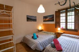 Postel nebo postele na pokoji v ubytování CASA CUARTEL EL VELERO