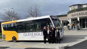 a group of people standing in front of a bus at The Gleneagle Hotel & Apartments in Killarney