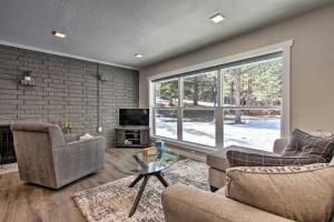 a living room with two couches and a large window at Modern Home with Wooded Views 10 Mi Outside Helena! in Helena