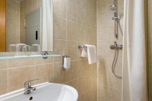 a bathroom with a sink and a shower at East City Budapest in Budapest
